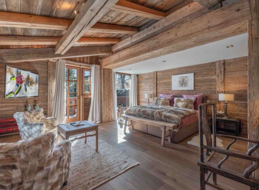 Experience the epitome of luxury in this stunning bedroom, featuring exquisite wooden accents and a cozy ambiance.
