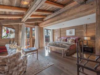 Experience the epitome of luxury in this stunning bedroom, featuring exquisite wooden accents and a cozy ambiance.
