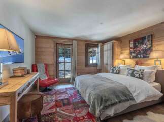 This cozy bedroom features a rustic wooden interior, creating a warm and inviting atmosphere.