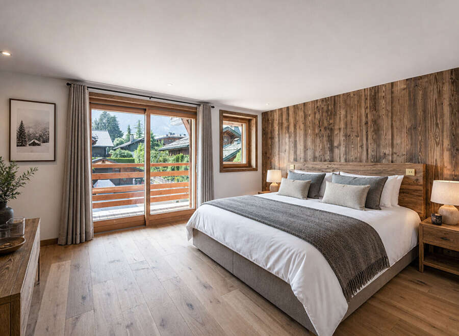 Experience luxury in this stunning bedroom featuring a rustic wooden accent wall and a cozy king-sized bed.