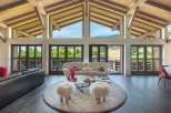 Experience luxury living in this stunning property, featuring a spacious living area with expansive windows that offer breathtaking views of the surrounding landscape.