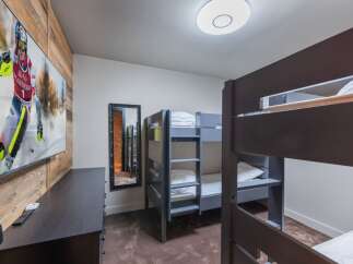 This cozy bedroom features bunk beds, perfect for accommodating guests or family members.