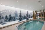 Indulge in luxury with this stunning indoor pool, featuring a breathtaking mountain mural that creates a serene and immersive atmosphere.