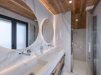 This luxurious bathroom features a modern design with a touch of rustic charm.