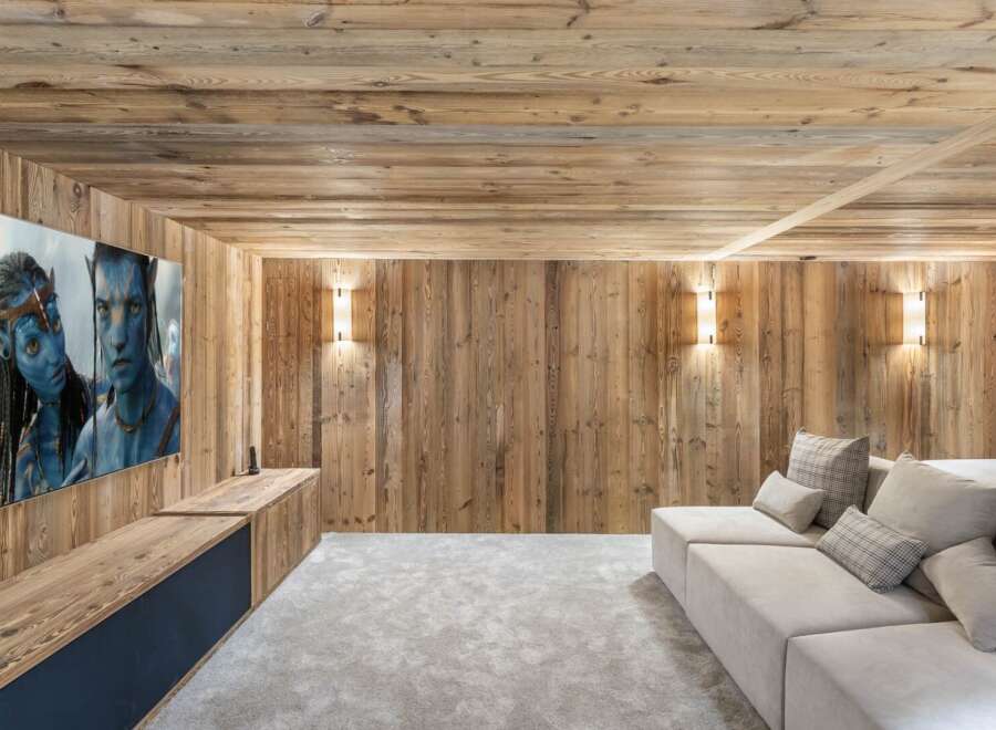 Experience luxury living in this stunning home theater! Featuring a large screen, comfortable seating, and a cozy ambiance, it's perfect for movie nights.