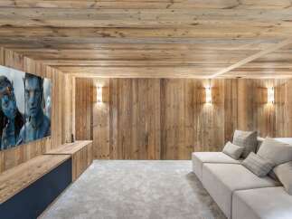 Experience luxury living in this stunning home theater! Featuring a large screen, comfortable seating, and a cozy ambiance, it's perfect for movie nights.