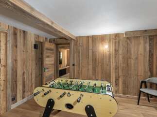 This stunning property boasts a rustic interior with wood paneling and exposed beams, creating a warm and inviting atmosphere.
