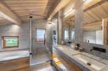 Experience luxury in this stunning bathroom featuring a sleek glass shower, dual sinks, and a modern design.