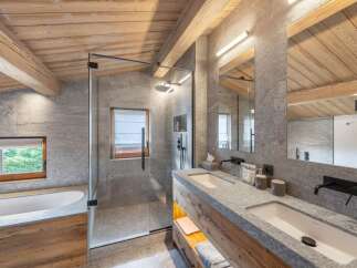 Experience luxury in this stunning bathroom featuring a sleek glass shower, dual sinks, and a modern design.