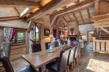 Step into luxury with this stunning chalet, featuring a warm and inviting dining area.