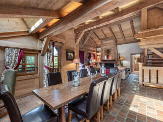 Step into luxury with this stunning chalet, featuring a warm and inviting dining area.