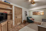 Discover the charm of this inviting living space, featuring a cozy armchair and a warm, inviting atmosphere.