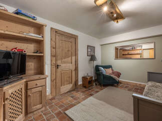 Discover the charm of this inviting living space, featuring a cozy armchair and a warm, inviting atmosphere.
