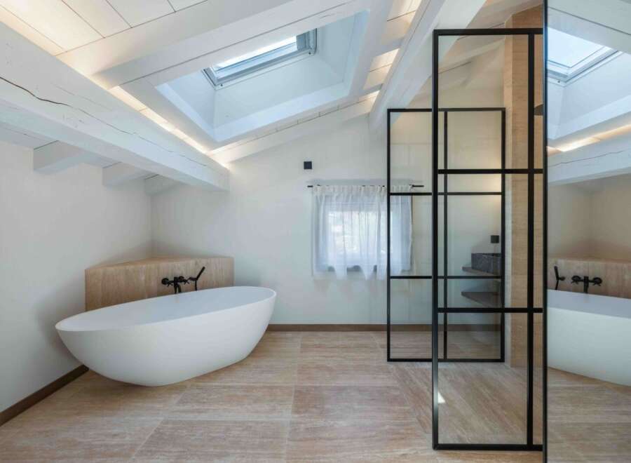 Experience luxury in this stunning bathroom featuring a modern freestanding tub and elegant glass shower enclosure.