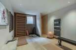 This modern home gym offers a serene space for fitness and relaxation.