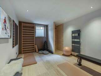 This modern home gym offers a serene space for fitness and relaxation.