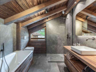 This stunning bathroom showcases rustic elegance with its wooden accents and modern design.