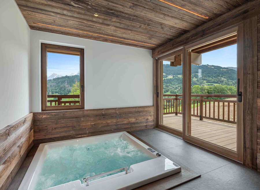 Indulge in luxury with this stunning property featuring a private hot tub and breathtaking mountain views.