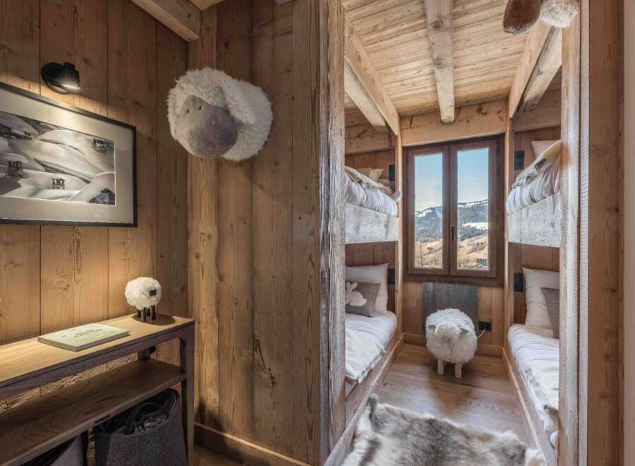 This cozy bedroom features custom-built bunk beds, perfect for a family getaway or a group of friends.