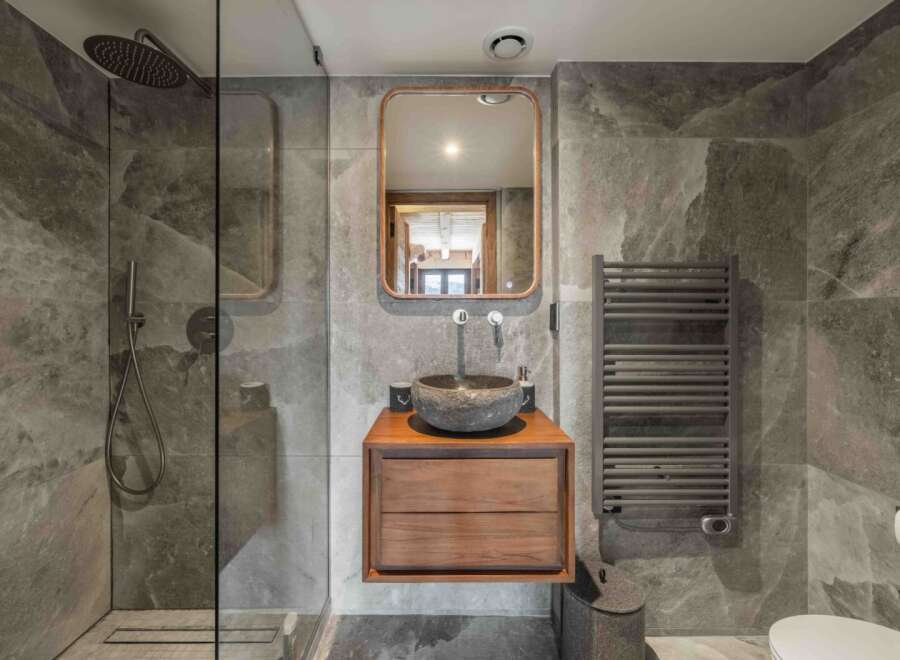 Step into luxury with this stunning bathroom, featuring a sleek, modern design.