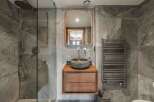 Step into luxury with this stunning bathroom, featuring a sleek, modern design.