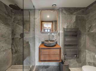 Step into luxury with this stunning bathroom, featuring a sleek, modern design.