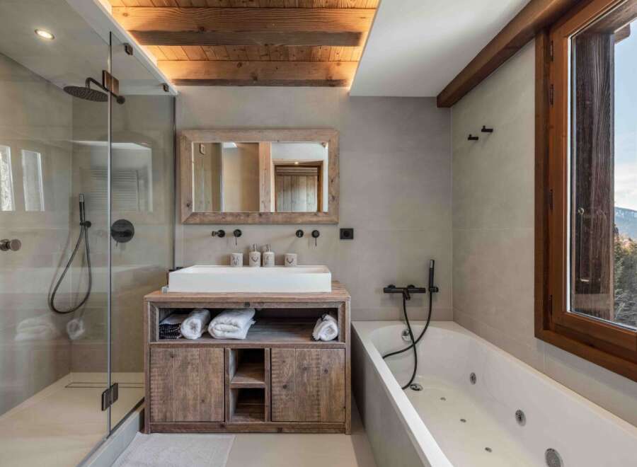 Experience luxury in this stunning bathroom featuring a modern shower and a relaxing bathtub.