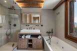 Experience luxury in this stunning bathroom featuring a modern shower and a relaxing bathtub.