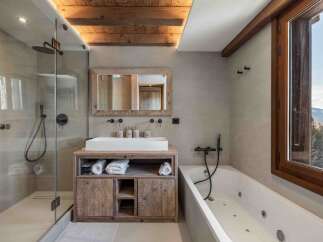 Experience luxury in this stunning bathroom featuring a modern shower and a relaxing bathtub.