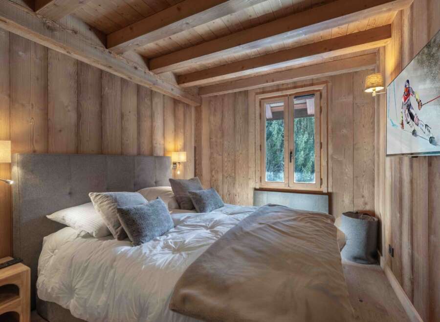 Experience the warmth of this cozy bedroom featuring stunning wooden accents throughout.
