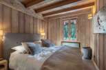 Experience the warmth of this cozy bedroom featuring stunning wooden accents throughout.