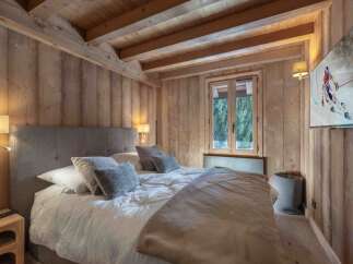 Experience the warmth of this cozy bedroom featuring stunning wooden accents throughout.