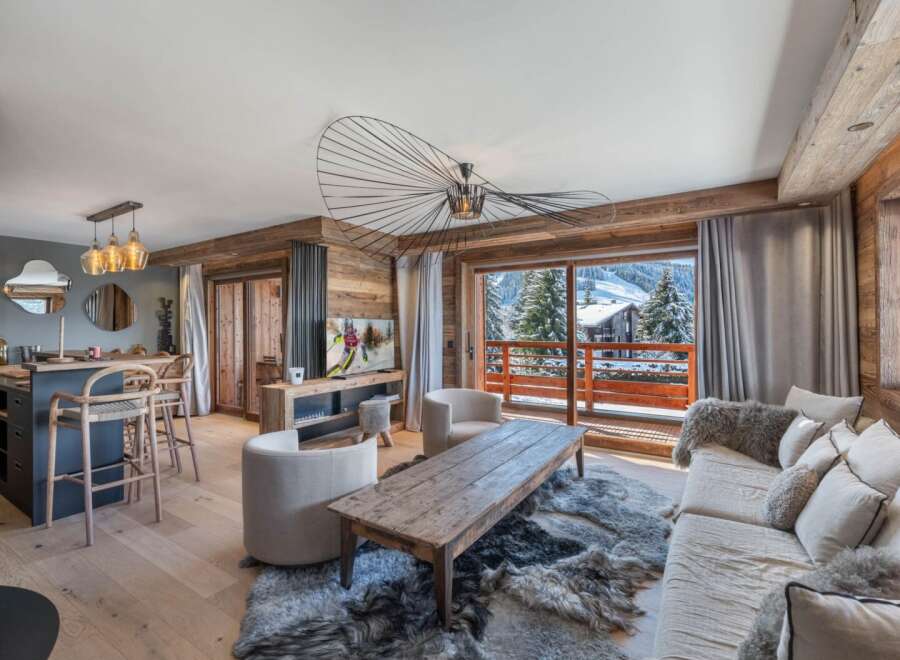 Experience luxury living in this stunning property, featuring a cozy living room with a fireplace and a gourmet kitchen.