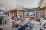 Experience luxury living in this stunning property, featuring a cozy living room with a fireplace and a gourmet kitchen.