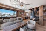 Experience luxury living in this stunning chalet, boasting a cozy fireplace and a modern spiral staircase.