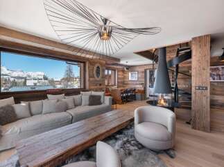 Experience luxury living in this stunning chalet, boasting a cozy fireplace and a modern spiral staircase.