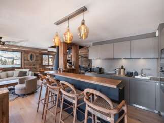 Experience luxury living in this stunning property, featuring a modern kitchen with sleek cabinetry and a stylish breakfast bar.