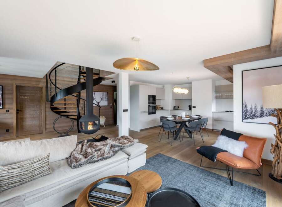 Experience luxury living in this stunning property, featuring a modern design with a cozy fireplace and a unique spiral staircase.