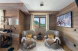 This cozy living space features a rustic wood-paneled interior, creating a warm and inviting atmosphere.