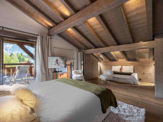 Experience luxury living in this stunning bedroom, featuring a cozy bed and a private balcony with breathtaking mountain views.