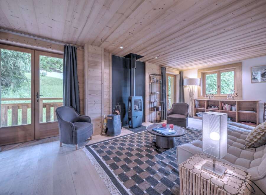 This cozy living room features a charming wood-paneled ceiling and walls, creating a warm and inviting atmosphere.