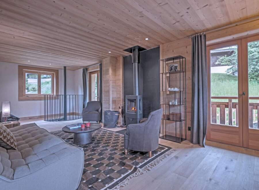 This cozy living space features a stunning wood-paneled ceiling and walls, creating a warm and inviting atmosphere.