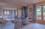 This cozy living space features a stunning wood-paneled ceiling and walls, creating a warm and inviting atmosphere.
