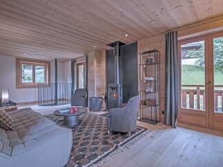 This cozy living space features a stunning wood-paneled ceiling and walls, creating a warm and inviting atmosphere.