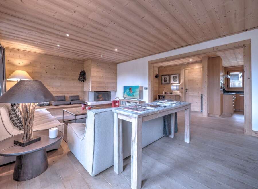 This stunning property boasts a warm and inviting interior with beautiful wooden accents throughout.