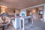 This stunning property boasts a warm and inviting interior with beautiful wooden accents throughout.