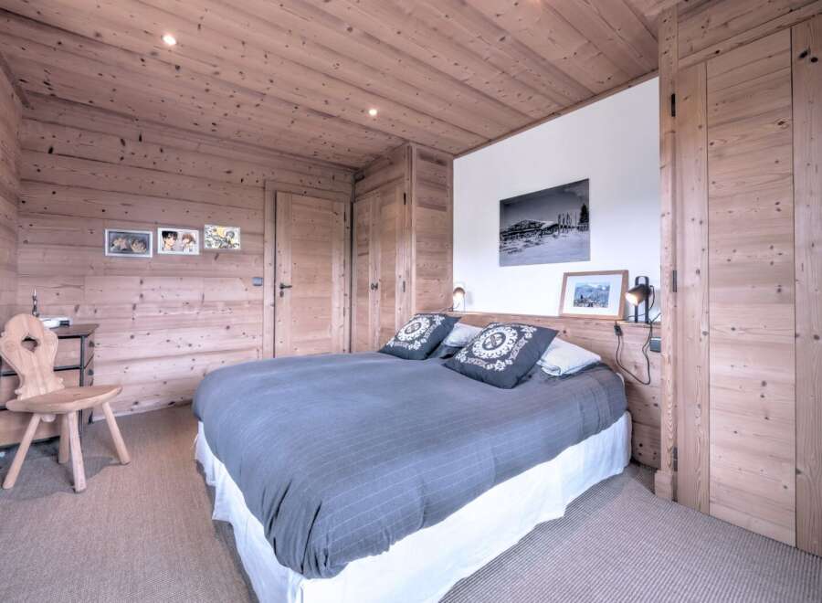 This cozy bedroom features a rustic wooden design, creating a warm and inviting atmosphere.