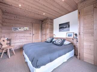 This cozy bedroom features a rustic wooden design, creating a warm and inviting atmosphere.