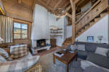 Experience the warmth of this stunning chalet, featuring a cozy fireplace and exposed wooden beams that create a rustic yet elegant ambiance.