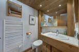 This charming bathroom features a warm, inviting design with natural wood accents.
